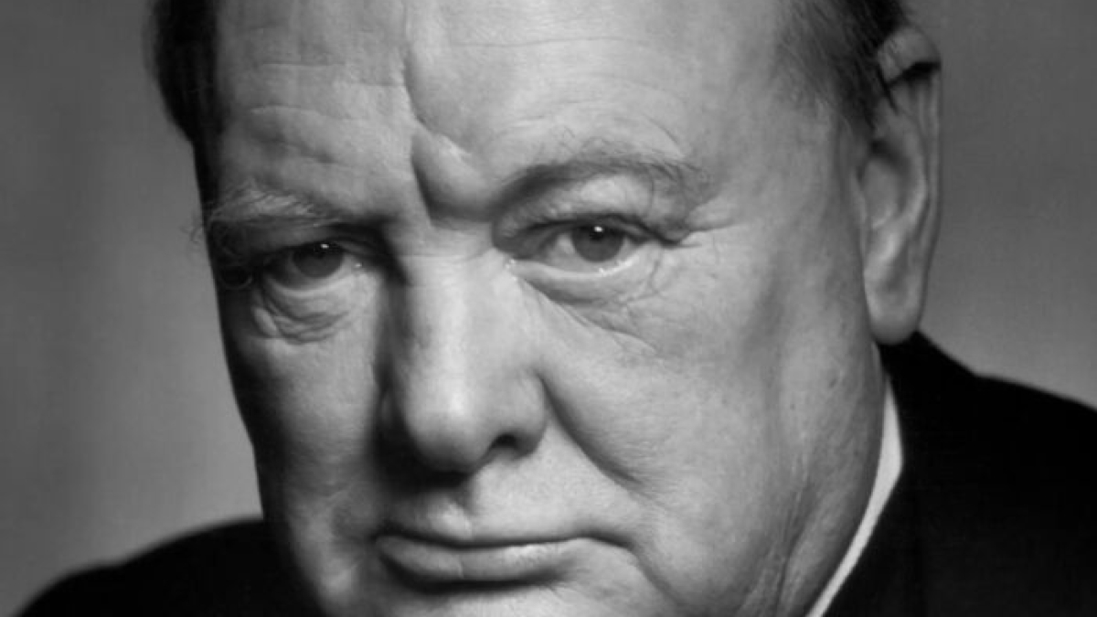 Close-up black and white portrait of a man with a serious expression, representing savage roasts and comebacks.
