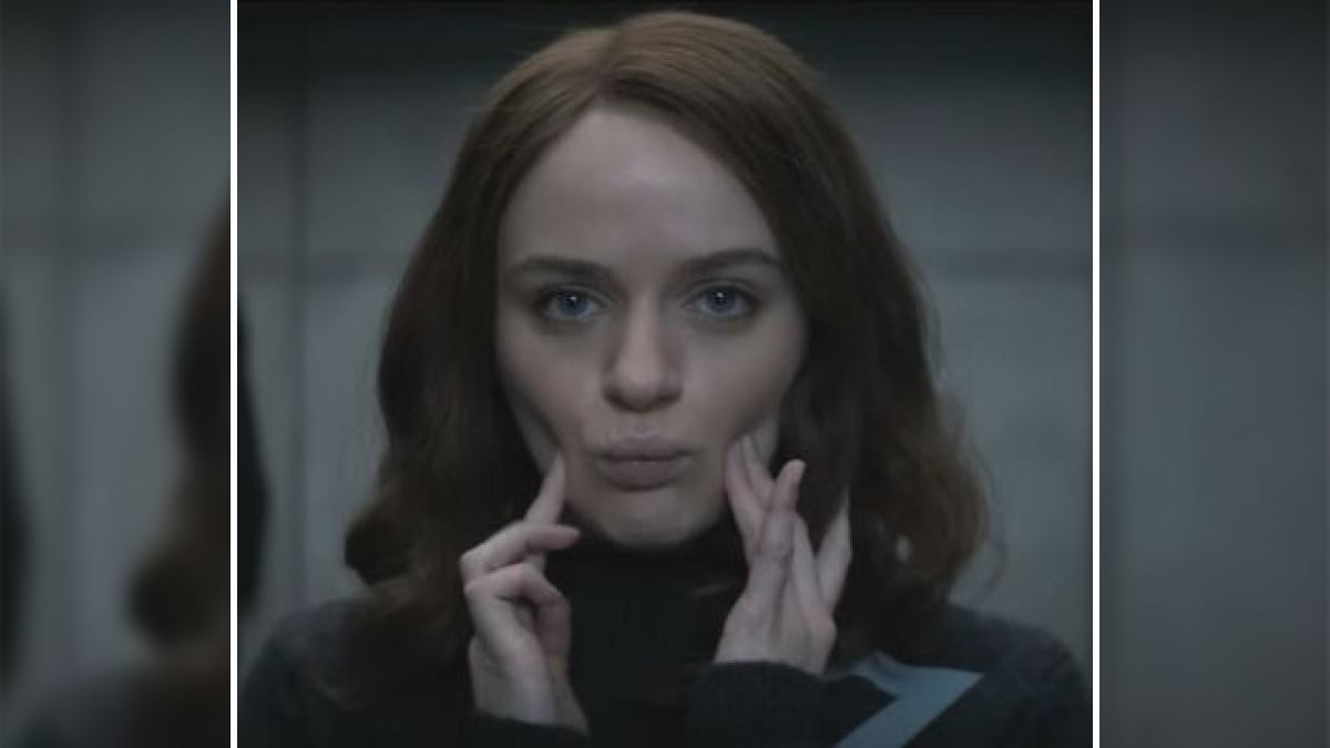 Young woman with serious expression touching her face, scene from Netflix movies that turned out to be letdowns.