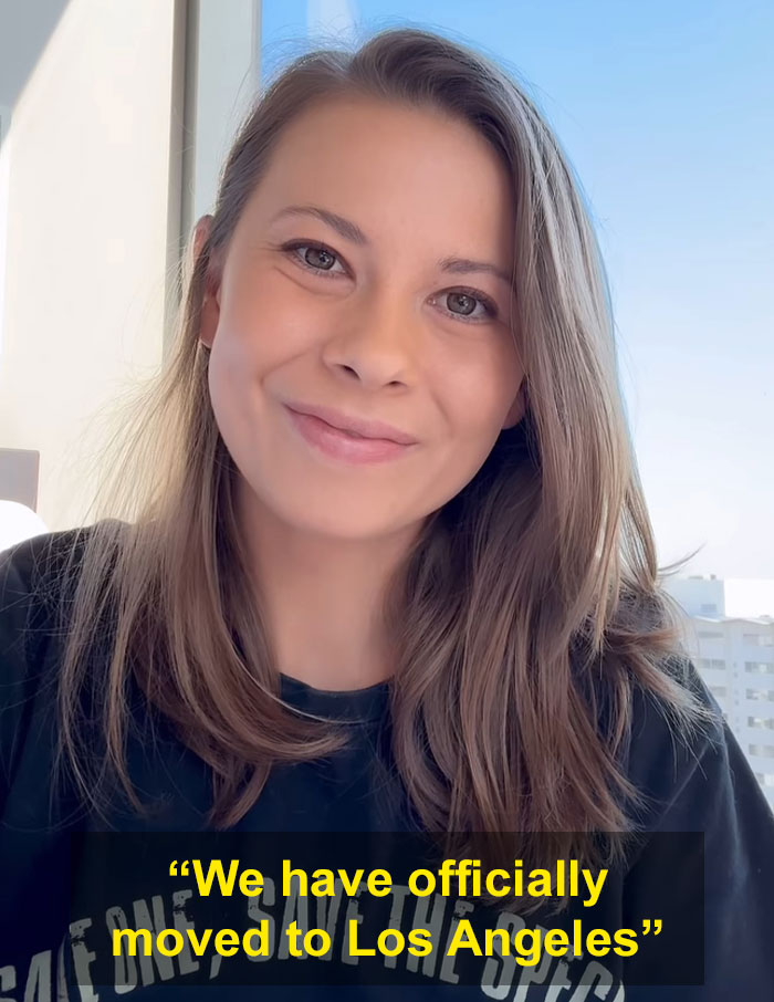 Bindi Irwin smiling indoors with text about her surprising decision to move from Australia to Los Angeles. Bindi Irwin smiling indoors with text about her surprising decision to move from Australia to Los Angeles.
