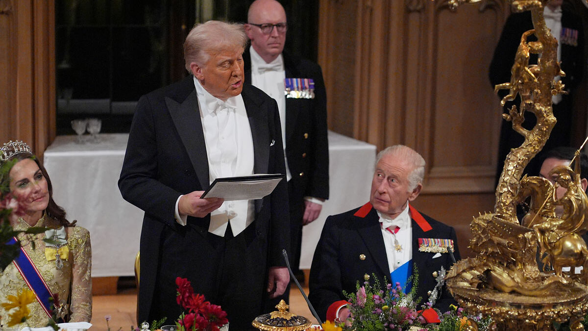 Donald Trump speaking while King Charles shows subtle signs of impatience during state visit dinner event.