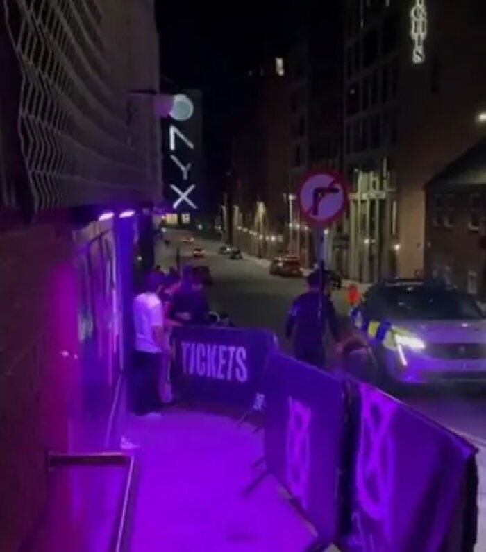 Nightclub entrance at night with purple lighting and people gathered outside during an incident involving adult star Bonnie Blue. Nightclub entrance at night with purple lighting and people gathered outside during an incident involving adult star Bonnie Blue.