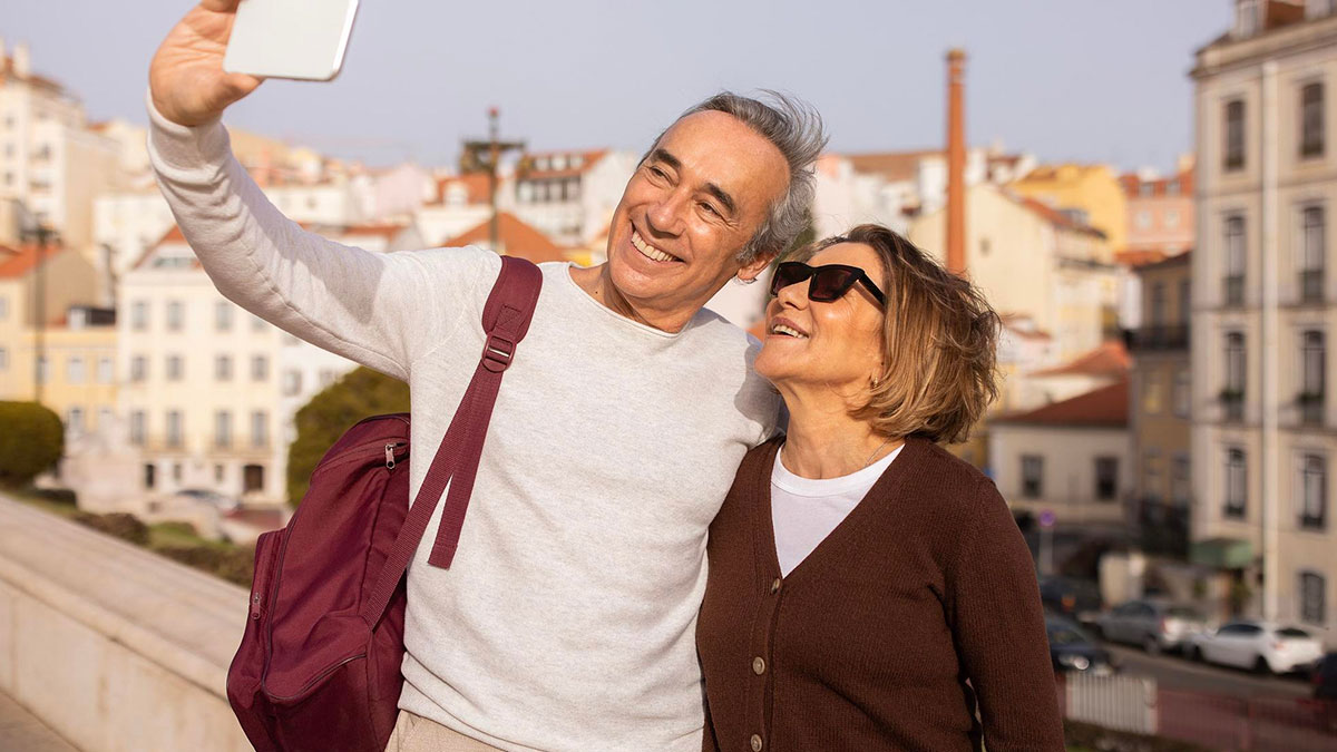 Middle-aged couple taking a selfie outdoors, smiling and happy, unrelated to cheating husband affair discovery.
