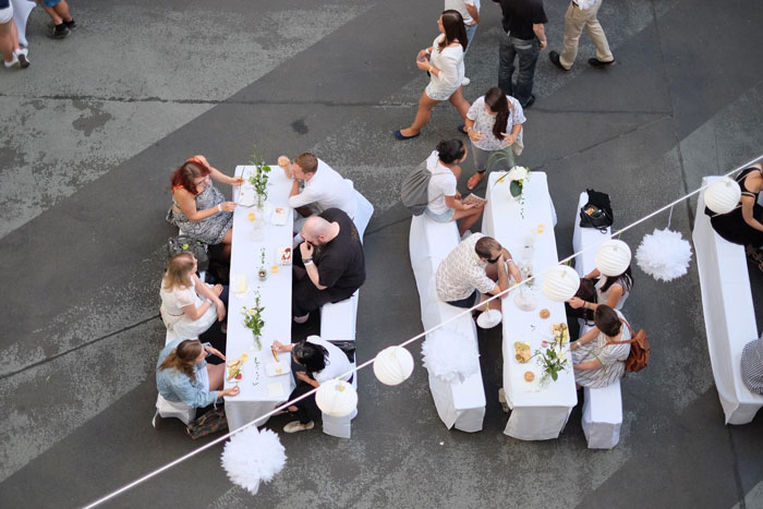 Guests seated at wedding tables outdoors, illustrating bride trust and loyalty issues after bridesmaid leaks seating chart. Guests seated at wedding tables outdoors, illustrating bride trust and loyalty issues after bridesmaid leaks seating chart.