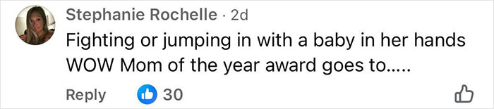 Comment on social media criticizing a mother for fighting while holding a baby, related to an angry mob ambushing a Walmart employee. Comment on social media criticizing a mother for fighting while holding a baby, related to an angry mob ambushing a Walmart employee.