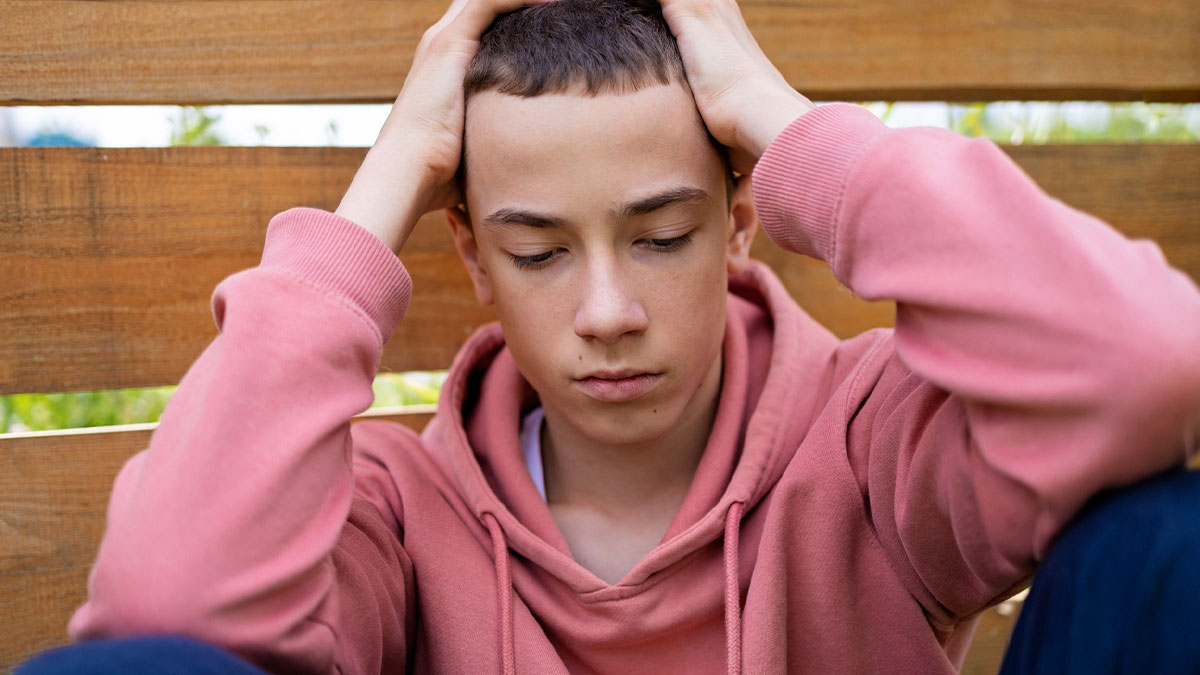 Stressed 18-year-old struggling single mom's son feeling overwhelmed juggling college and raising five siblings.