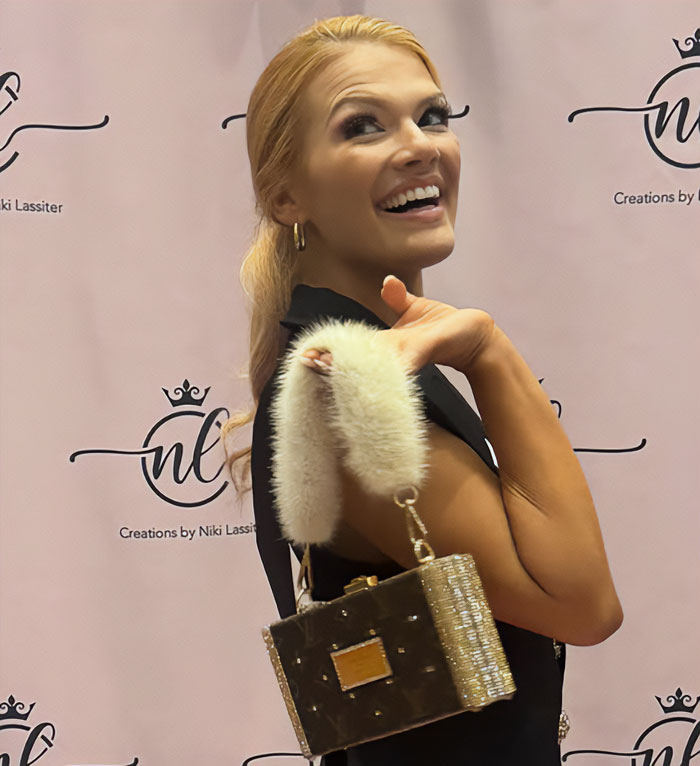 Miss America smiling and posing with stylish handbag, addressing backlash over her look after winning the pageant. Miss America smiling and posing with stylish handbag, addressing backlash over her look after winning the pageant.