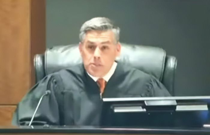 Judge wearing black robe presiding over a court session involving suspect Tyler Robinson in the Charlie Kirk case. Judge wearing black robe presiding over a court session involving suspect Tyler Robinson in the Charlie Kirk case.