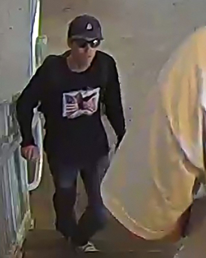 Man wearing sunglasses and cap, walking indoors, related to NBC analyst breaking silence after firing controversy. Man wearing sunglasses and cap, walking indoors, related to NBC analyst breaking silence after firing controversy.