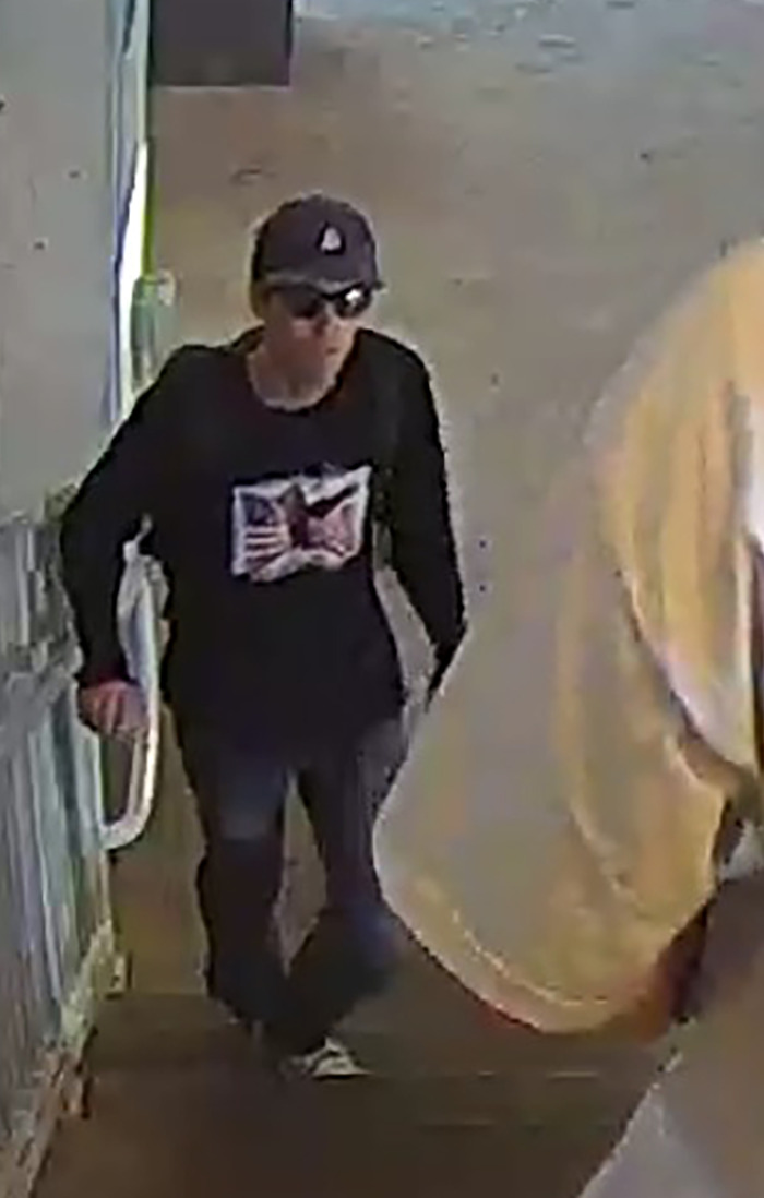 Person wearing sunglasses and a hat, walking on a rooftop staircase related to Charlie Kirk sniper’s rooftop nest POV investigation. Person wearing sunglasses and a hat, walking on a rooftop staircase related to Charlie Kirk sniper’s rooftop nest POV investigation.