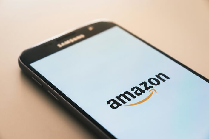 Samsung smartphone displaying the Amazon logo, illustrating popular overhyped products people say to stop buying.