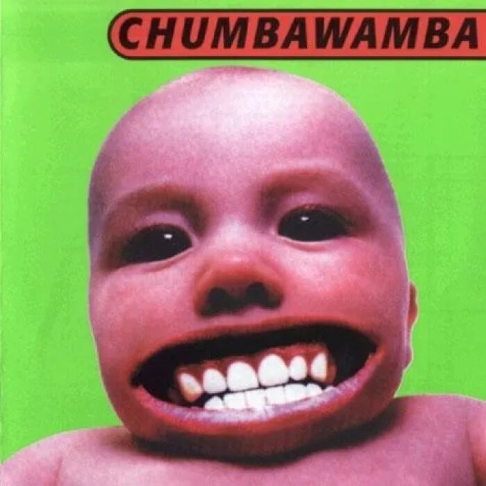 Surreal album cover featuring a baby with an exaggerated wide mouth and large teeth on a bright green background.