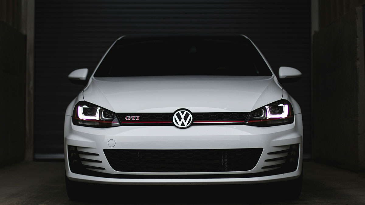 White Volkswagen GTI with headlights on, illustrating examples of companies sabotaging their own products by netizens.