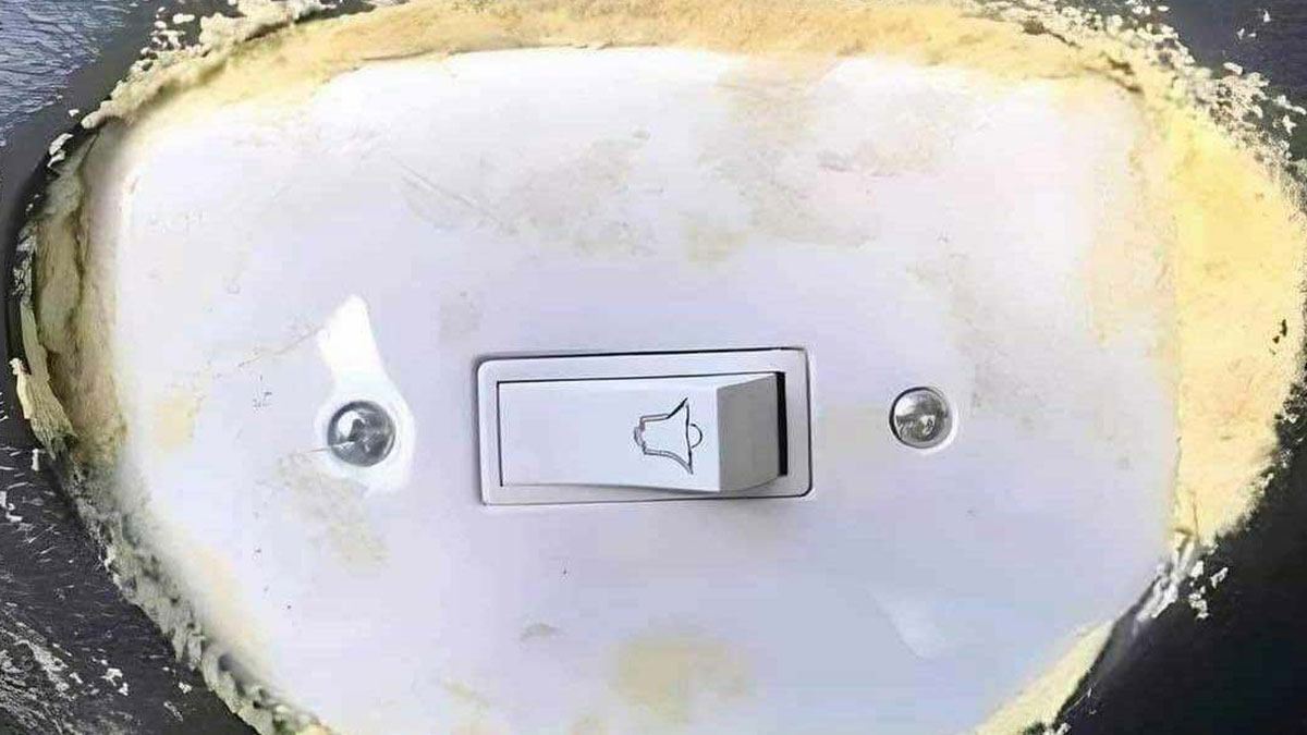 A poorly installed construction design showing a switch with uneven and messy surrounding drywall edges.