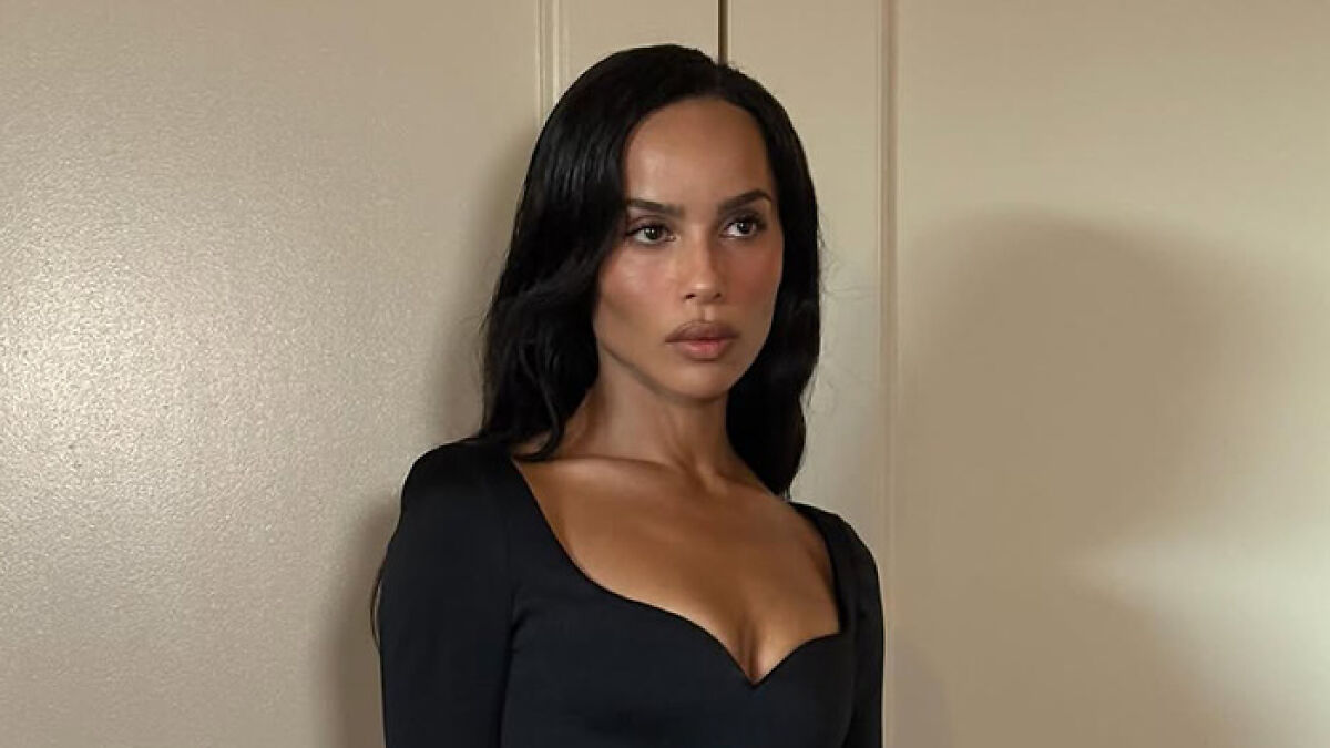 Zou00eb Kravitz wearing a black dress, posing indoors while discussing why friends belong in the past.