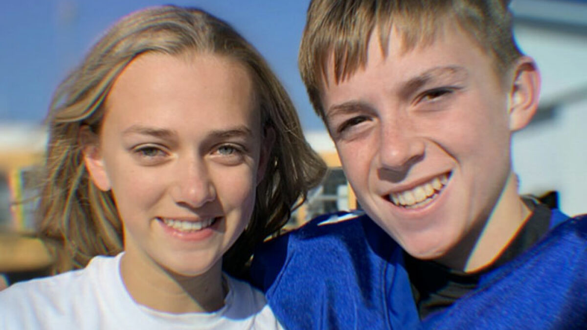 Teen girl and boyfriend smiling outdoors, representing victims tormented by sick catfish and obsessed mom culprit.
