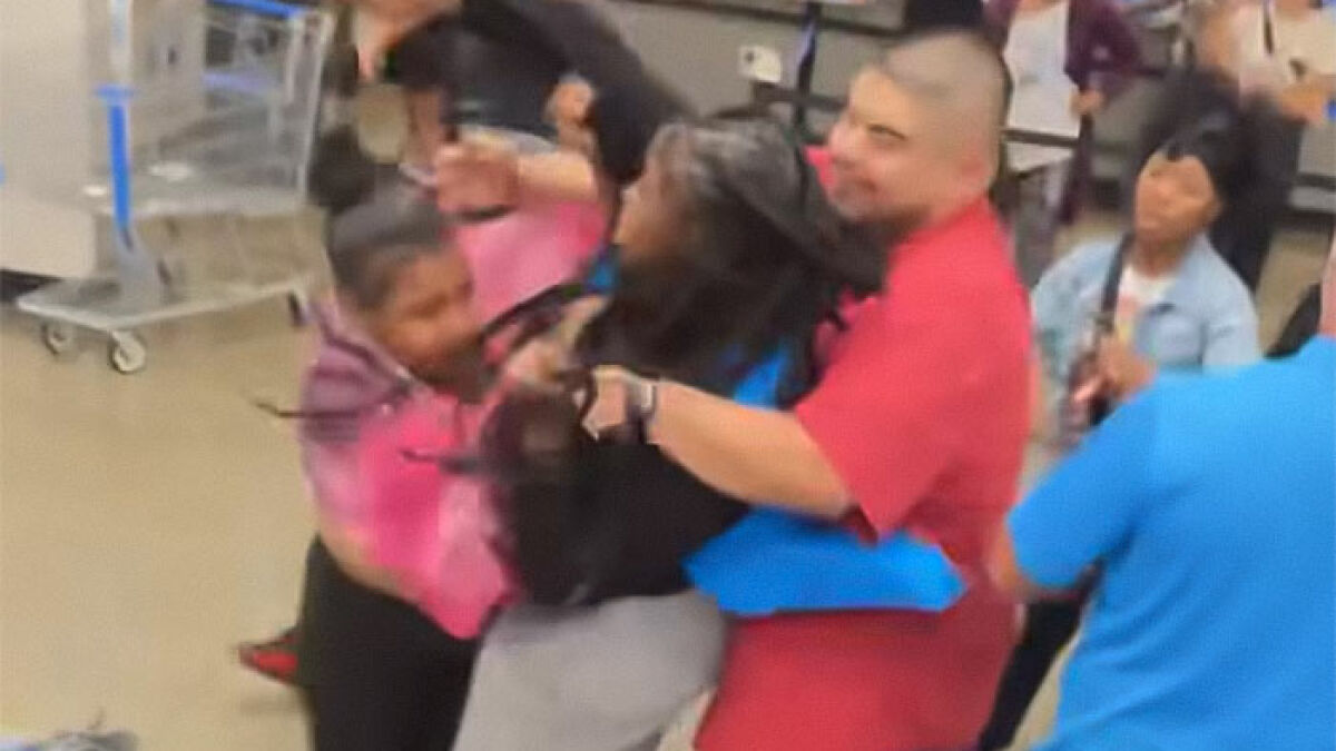 Angry mob confronts Walmart employee as others try to intervene inside store during a viral disturbance video.