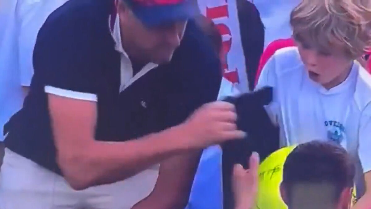 Disgraced CEO grabbing boy's cap at US Open, boy reacting in shock as video goes viral at tennis event.