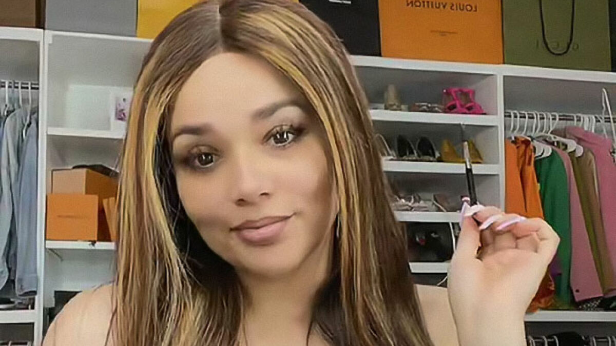 Esmeralda Ferrer Garibay, influencer, posing in a closet with various clothing and luxury bags in the background.