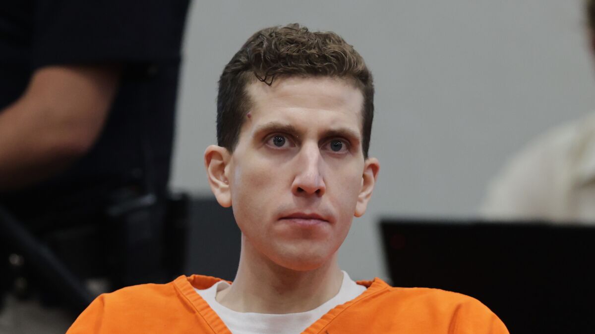 Man in orange prison jumpsuit with short curly hair in a courtroom setting, related to Bryan Kohberger Idaho crimes case.