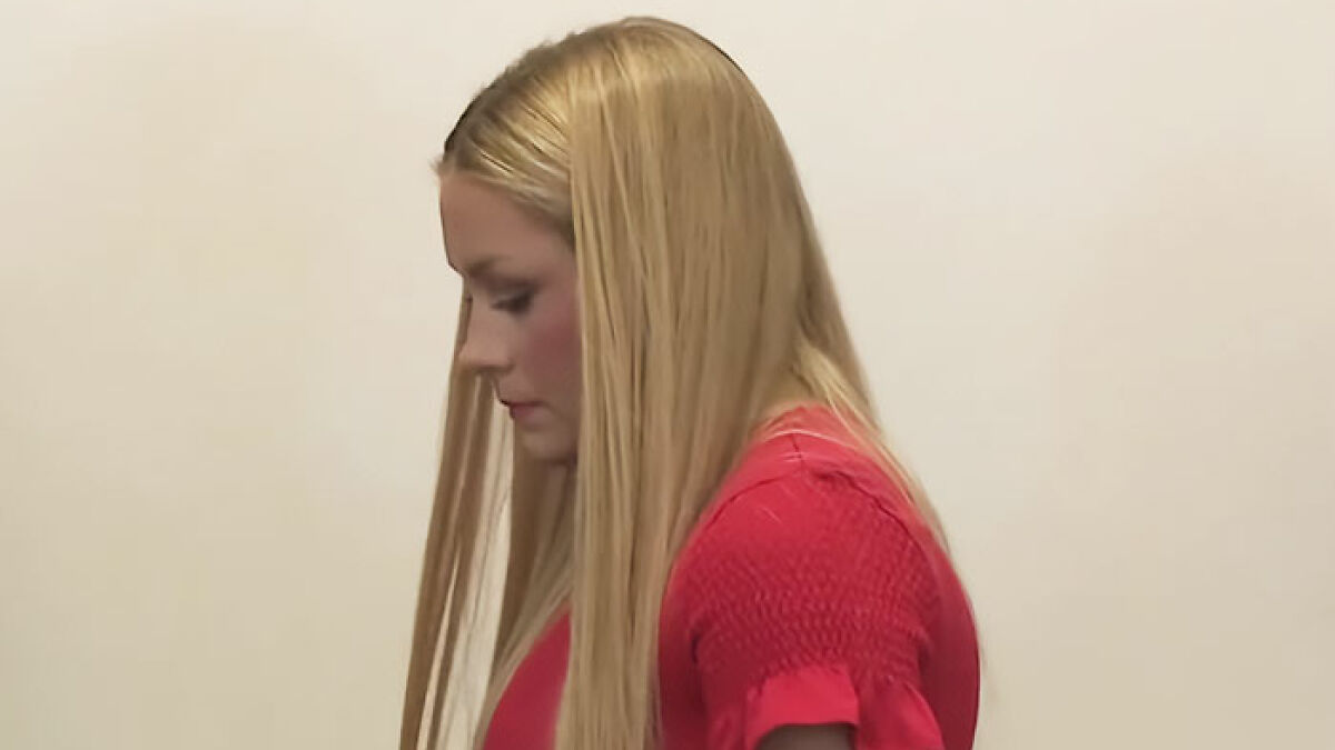 Young woman with long blonde hair in a red shirt, related to autopsy findings for newborn found in cheerleader's closet