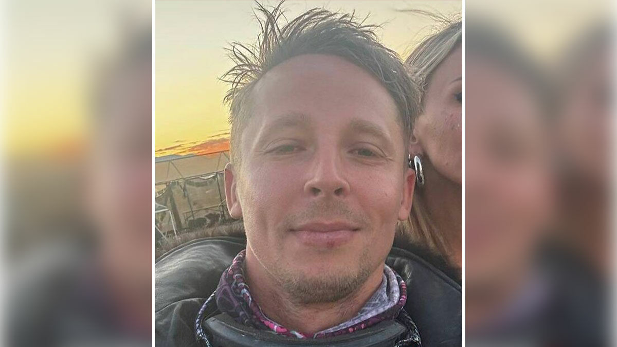 Close-up of a man with disheveled hair outdoors during sunset, related to Burning Man victim and justice demands.