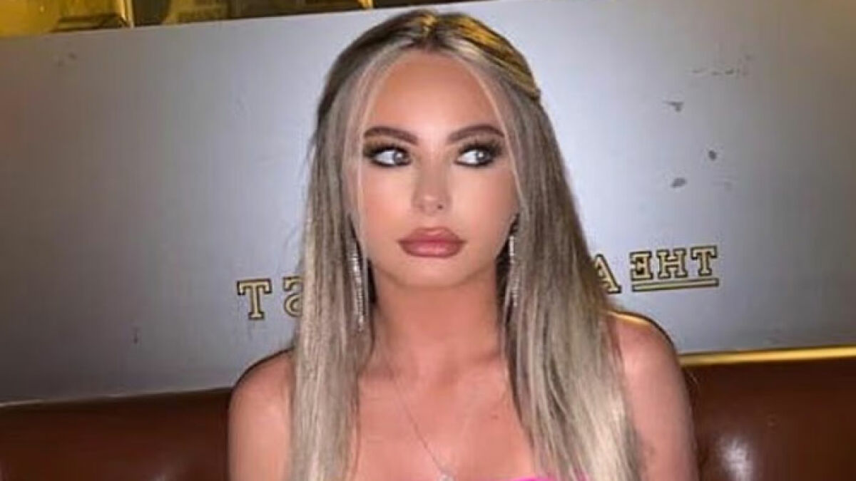 Young woman with long blonde hair and makeup sitting indoors, related to law student jailed for life in Dubai.