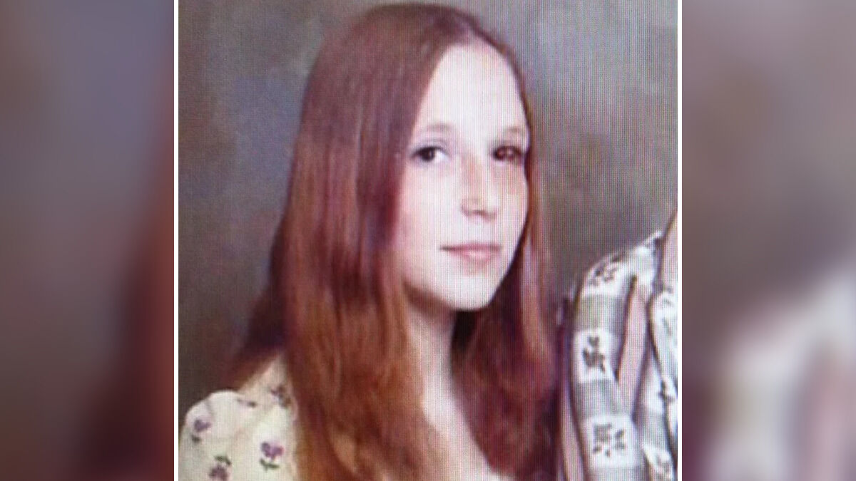 Teen with long red hair in a floral shirt, part of a survival story about a homicide serial spree escape.