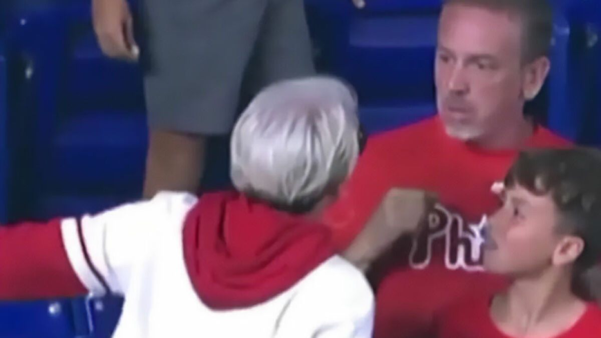 Woman mistaken for Phillies Karen in heated confrontation during home run ball incident at baseball game.