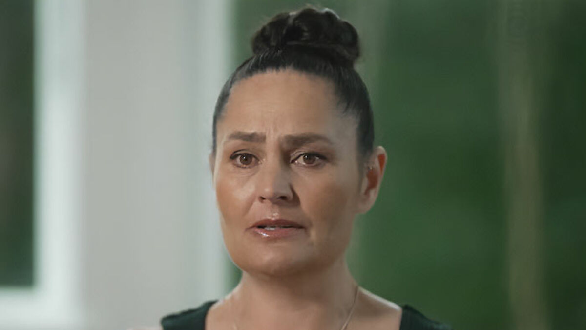 Woman with hair in a bun, appearing emotional while speaking about kids who vanished into wilderness and the released campsite photos