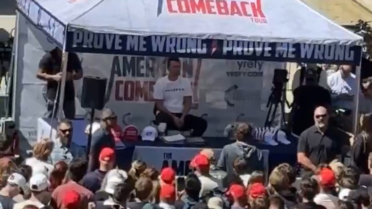 Crowd gathered at Utah event with Charlie Kirk seated under a tent during mid-speech incident involving gunman.