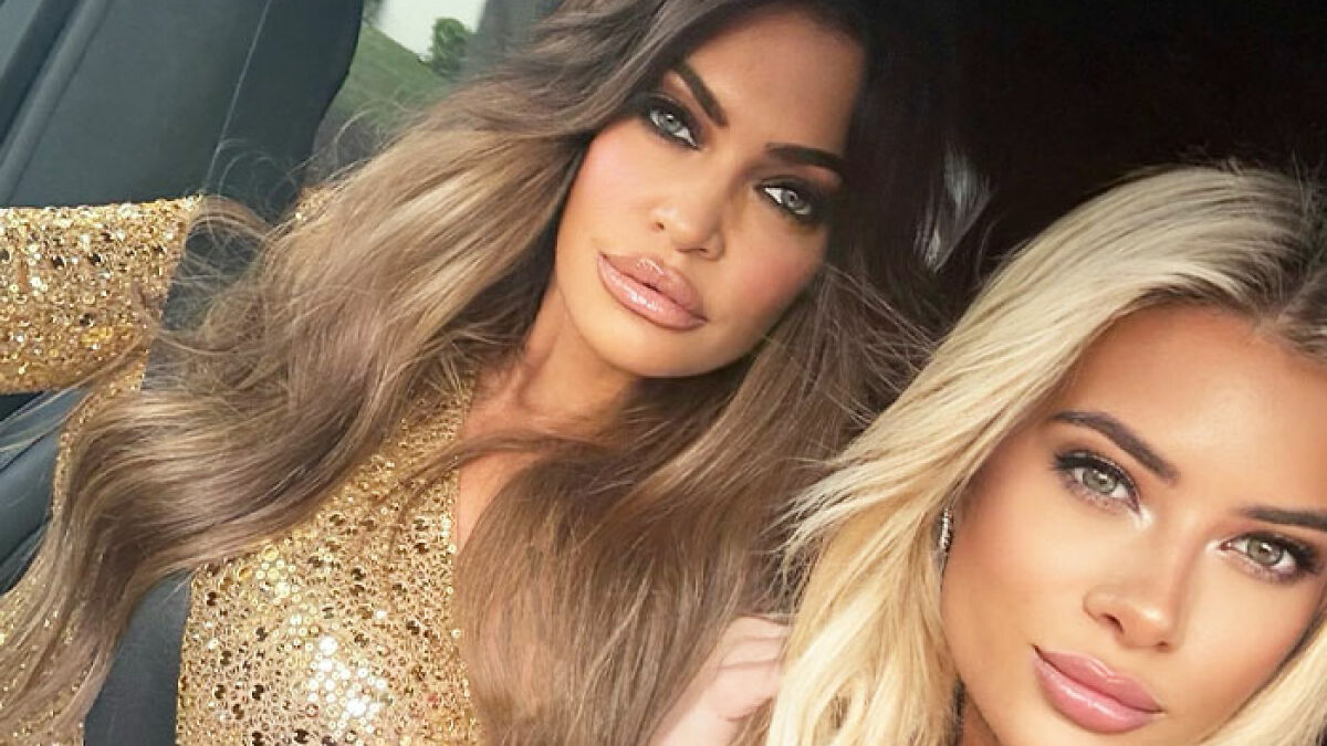 Kimberly Guilfoyle with enhanced lips posing with a friend wearing glamorous makeup and stylish outfits in a car.