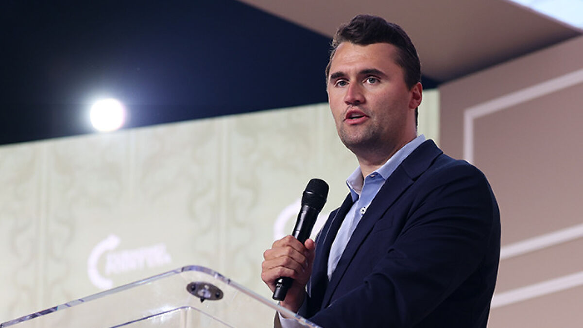 Charlie Kirk speaking at an event, holding a microphone, related to person of interest photo FBI release after fatal attack.