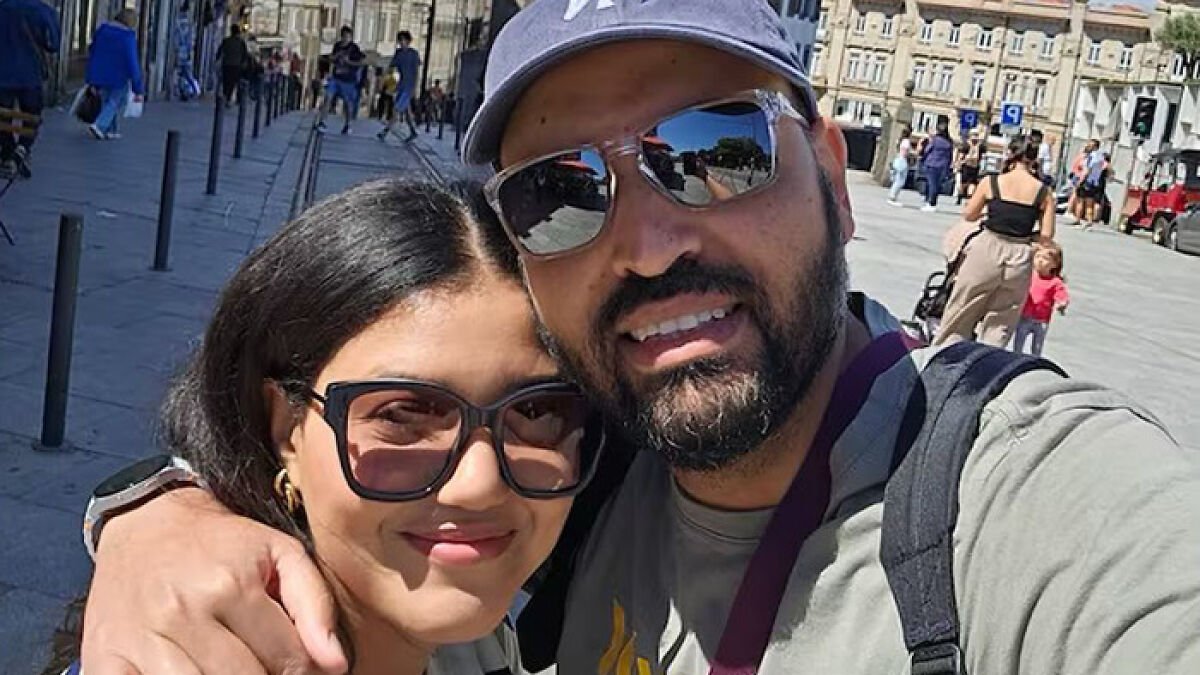 Couple smiling for a selfie outdoors in Lisbon, related to husband swapping seats with wife and Lisbon crash news.