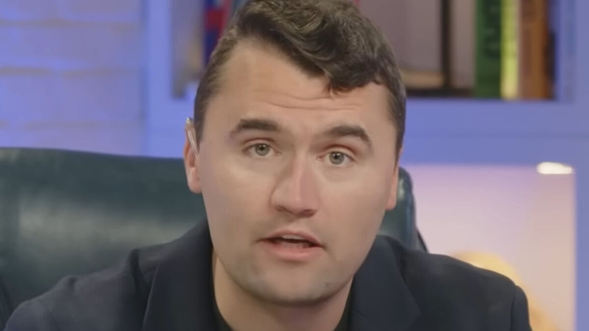 Man speaking in a studio setting about Charlie Kirk bullying claims during high school affecting his will to live.