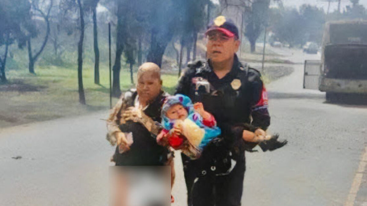 Heroic grandma being escorted by police after saving 2-year-old from fire during Mexico City explosion emergency response.