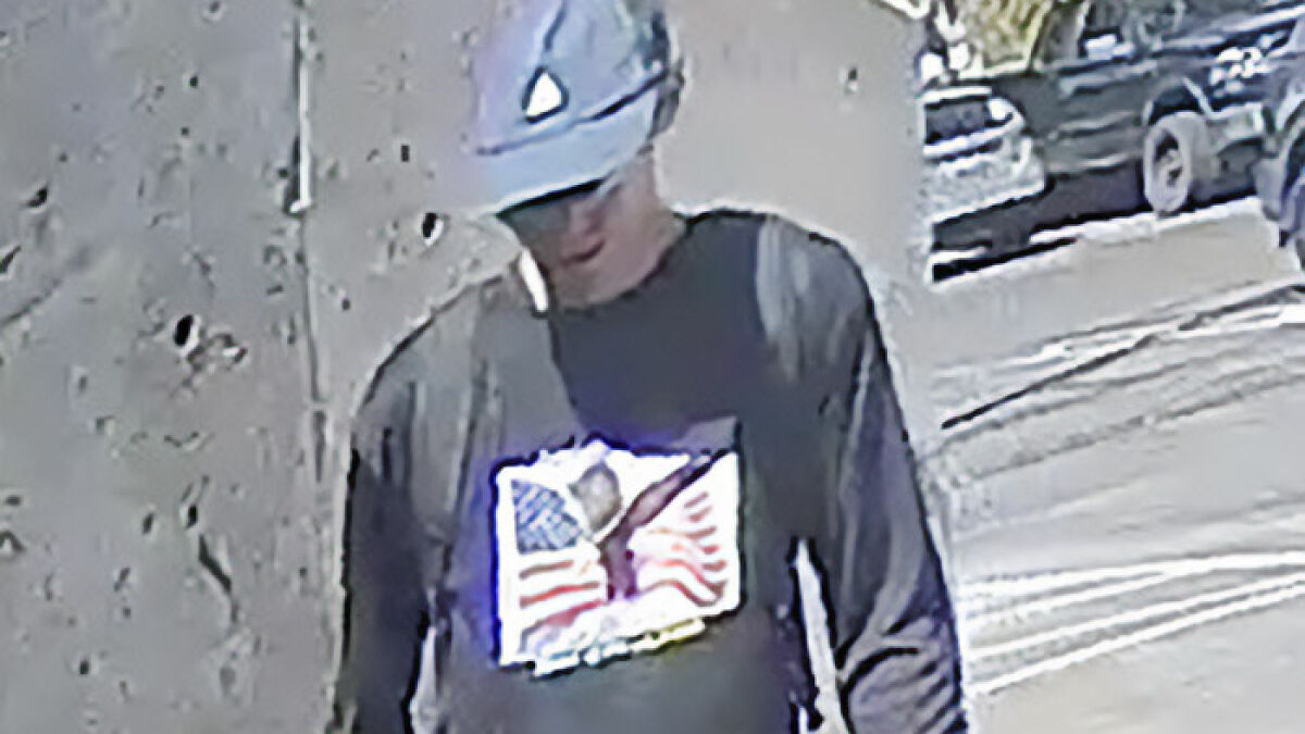 CCTV footage shows main suspect wearing a helmet and dark shirt near a textured wall during escape attempt.