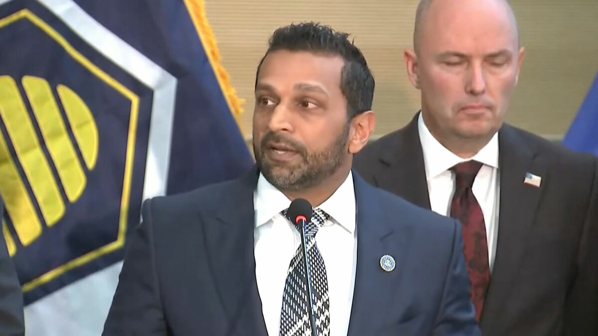 FBI officials speaking at a press conference about the capture of Charlie Kirk's assassin and related details.