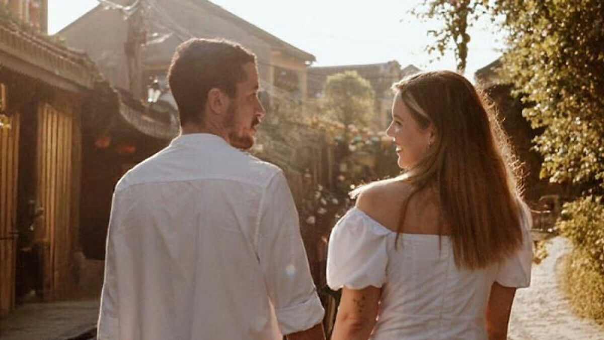 Newly engaged couple walking outdoors, symbolizing tragic twist in poisoned limoncello case as parents seek justice.