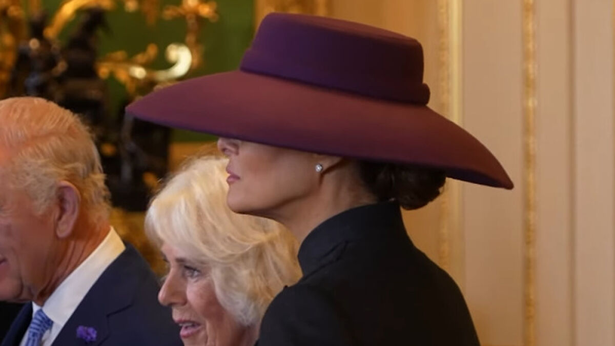 Melania Trump wearing a large hat during a meeting with the British Royal Family sparking body double conspiracy.