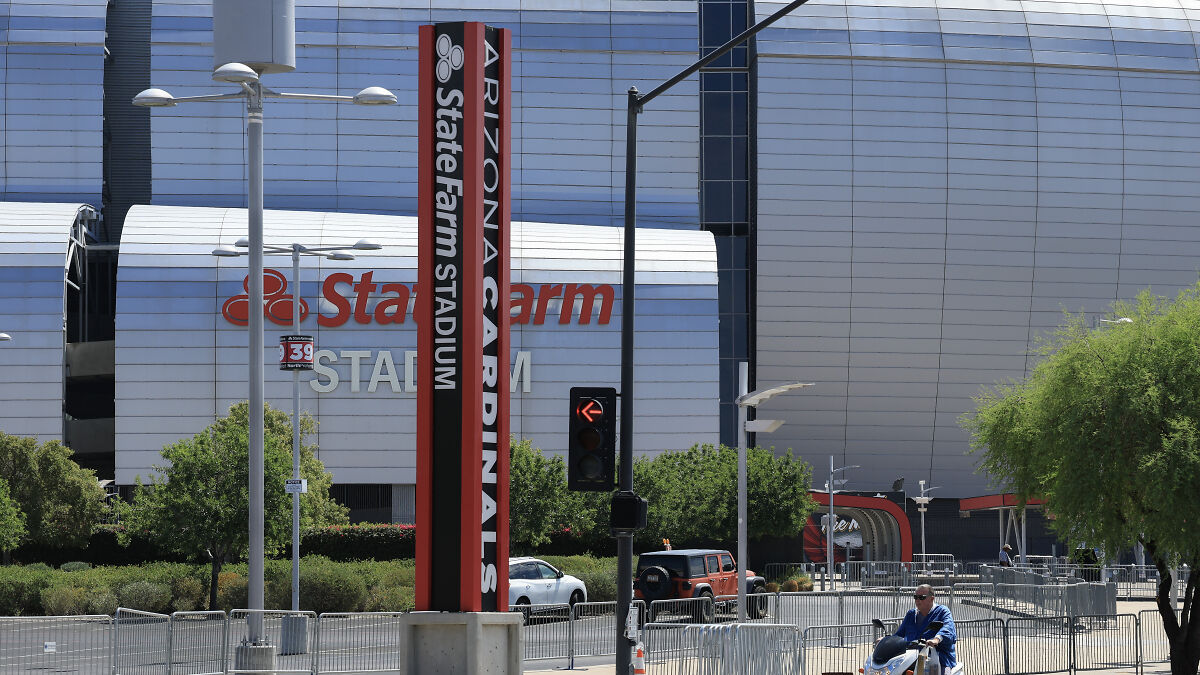 Arizona Cardinals stadium exterior with security barriers amid Charlie Kirk memorial attack fears and gunman concern.