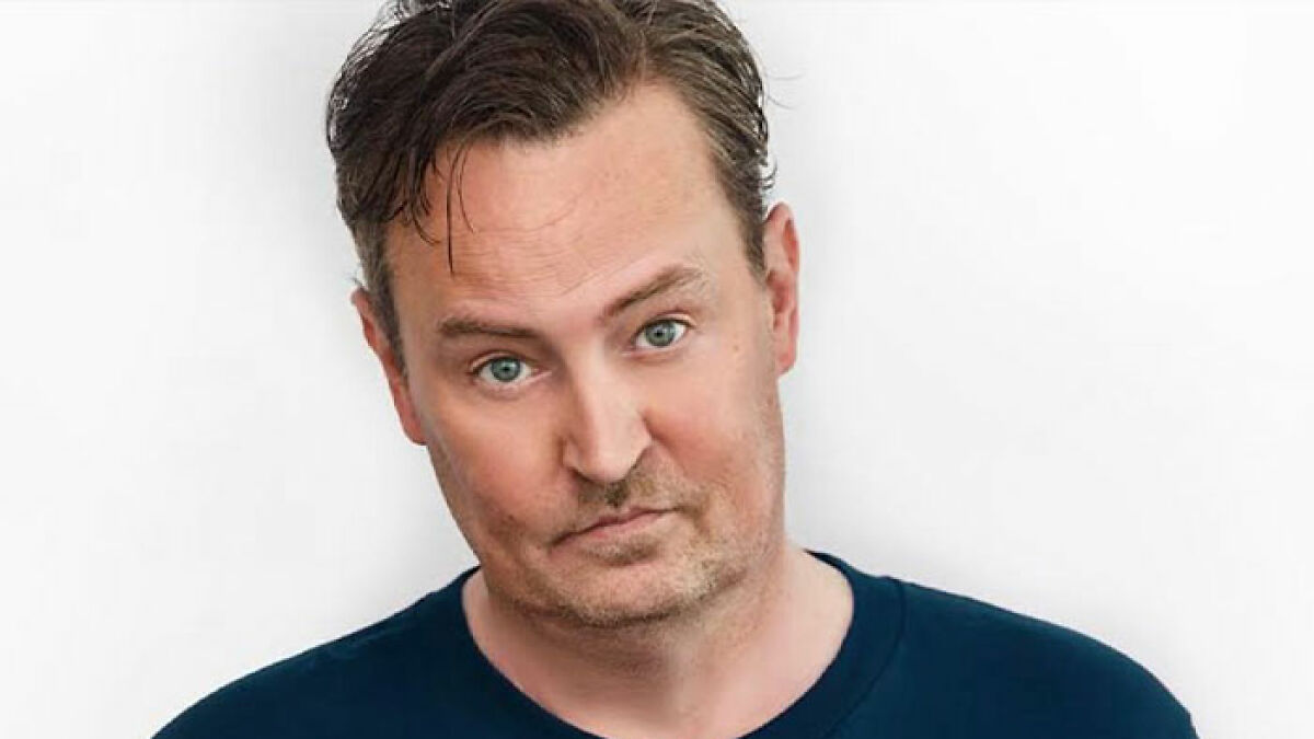 Man with a skeptical expression in a navy shirt, representing raw and unfiltered confessions celebs shared in their memoirs.