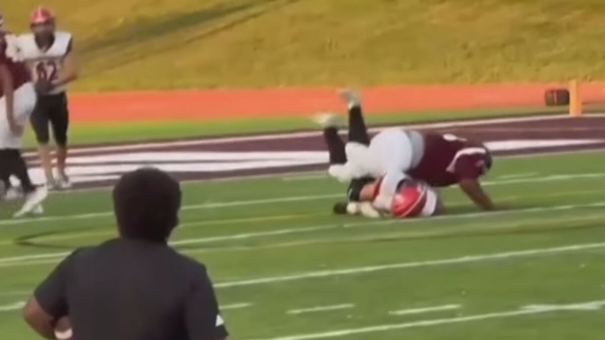 Teen footballer tackled hard on the field, highlighting the moment leading to a spine fracture injury.