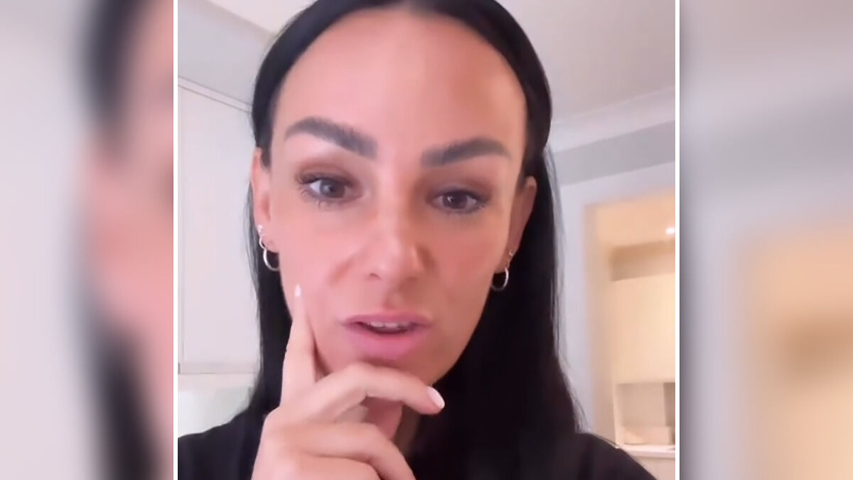 Furious mom with dark hair speaking indoors, sharing her reaction to son being banned from eating a common school snack.