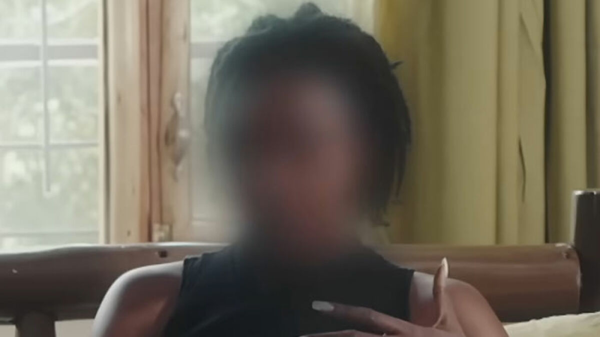 Young woman with blurred face speaking out about the horror of Dubai's infamous Porta Potty Parties indoors.