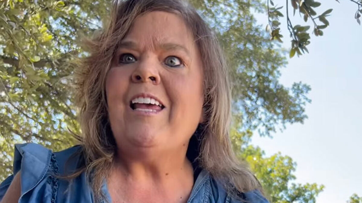 Middle-aged woman having a heated confrontation outdoors, related to Texas Karen's racist meltdown involving Hispanic delivery driver.
