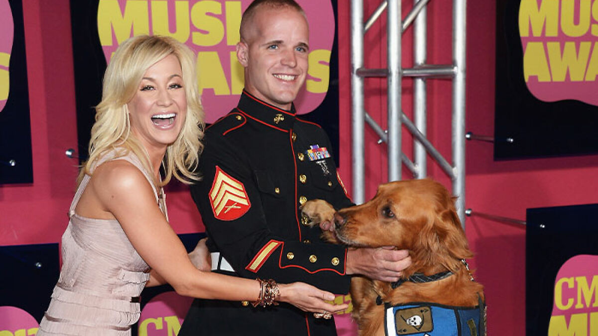 North Carolina mass attack suspect with American Idol star at music awards event, posing with a service dog.