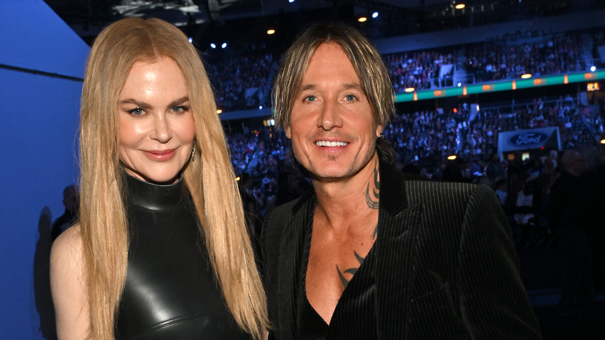 Nicole Kidman and Keith Urban smiling together at a crowded event, sparking hilarious reactions to their split.