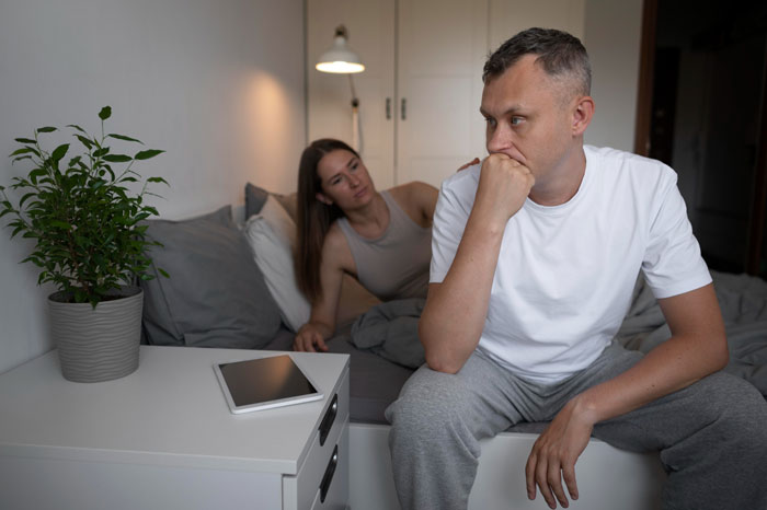 Teen cuddles up against dad in bedroom, while concerned woman watches, illustrating family tension and accusations of crossing limits. Teen cuddles up against dad in bedroom, while concerned woman watches, illustrating family tension and accusations of crossing limits.