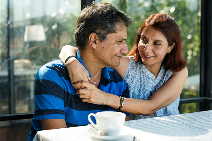 Middle-aged man and woman sharing a tender moment, highlighting stepkids and stepdad inheritance conflict theme. Middle-aged man and woman sharing a tender moment, highlighting stepkids and stepdad inheritance conflict theme.