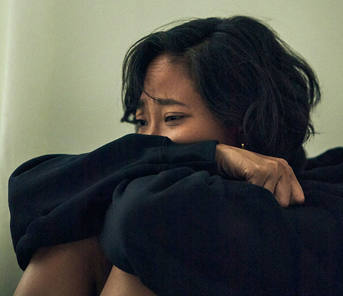 Woman sitting alone looking distressed, illustrating inlaws push boundaries during divorce conflicts. Woman sitting alone looking distressed, illustrating inlaws push boundaries during divorce conflicts.